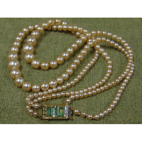 6 - Two string cultured pearl necklace, together with another single string example. (2)