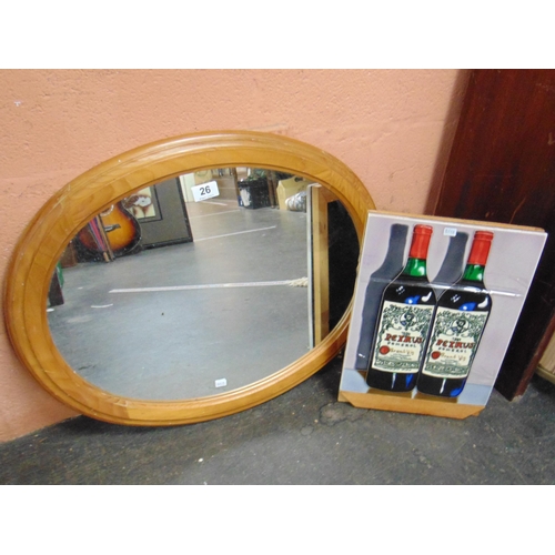 26 - Oval pine framed mirror and a tile depicting wine bottles.