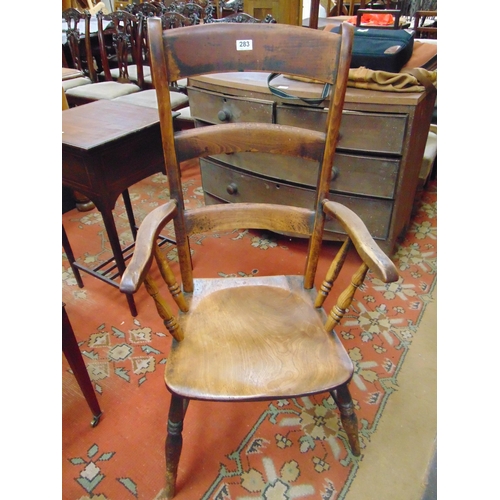 283 - An elm farmhouse ladder back armchair, solid seat, on turned supports and stretchers.