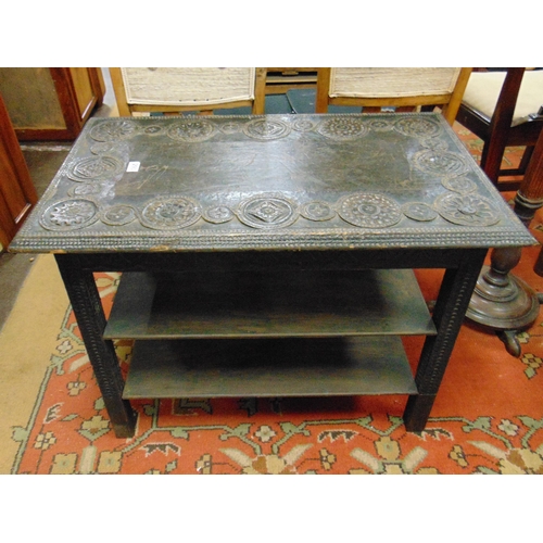 293 - Ebony centre table, carved rectangular top, on square supports joined by two further tiers. 25 x 33 ... 