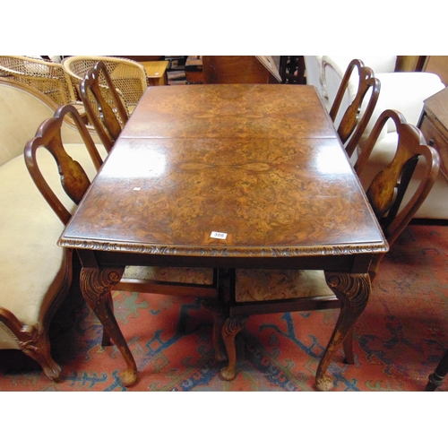 308 - Walnut veneered dining room suite, comprising extending table, four chairs and sideboard.