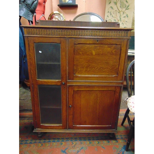 314 - An oak bureau, raised back over fall front, glazed door and further door to base. 50 x 37 x 12