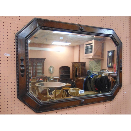 328 - An oak octagonal form bevel edged wall mirror, having beaded edging. 24 x 34