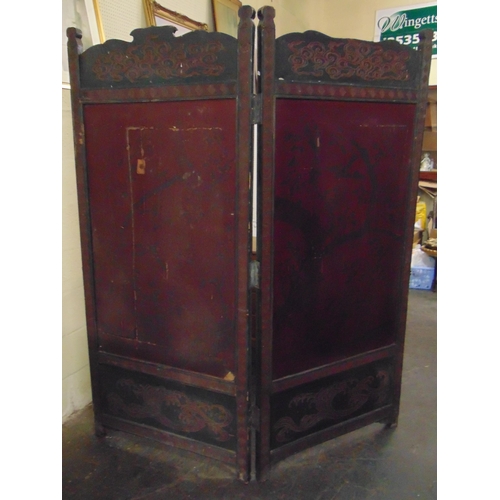 337 - An oriental double fold carved ebony screen, having traditonal silk work decoration.  76 x 56