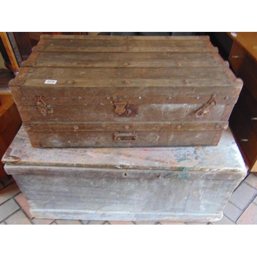 372 - Antique pine trunk having lift up lid and metal side handles, together with a smaller example. (2)