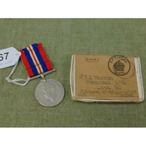 67 - Second World War medal in book.