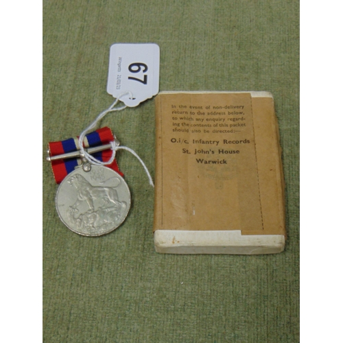 67 - Second World War medal in book.