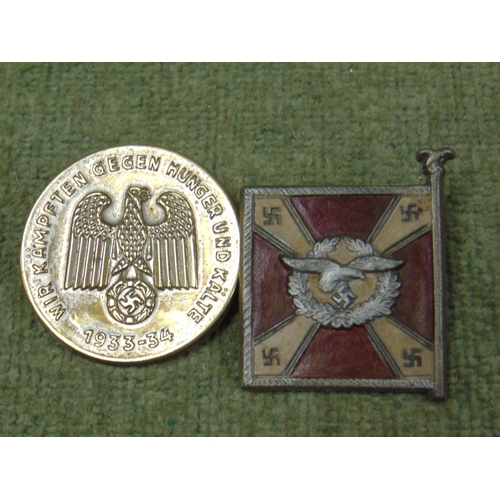 83 - Nazi Fighting against hunger and cold badge and a Veterans contribution flag badge. (2)