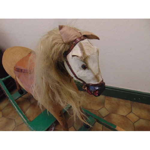 100 - 19th century rocking horse, set on painted base, for restoration.  42 x 54