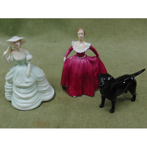 151 - Two Coalport figurines, Joanne and Carla, together with a Beswick Black Labrador. (3)