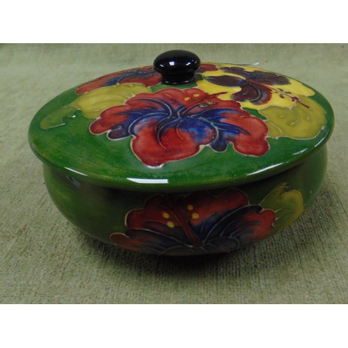 157 - Moorcroft lidded bowl, having floral decoration and original paper label. - Restored.