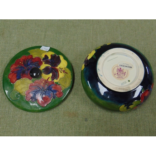 157 - Moorcroft lidded bowl, having floral decoration and original paper label. - Restored.