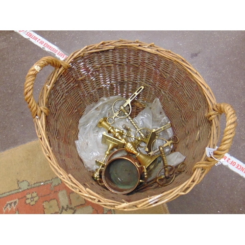 221 - Wicker basket containing some brassware.