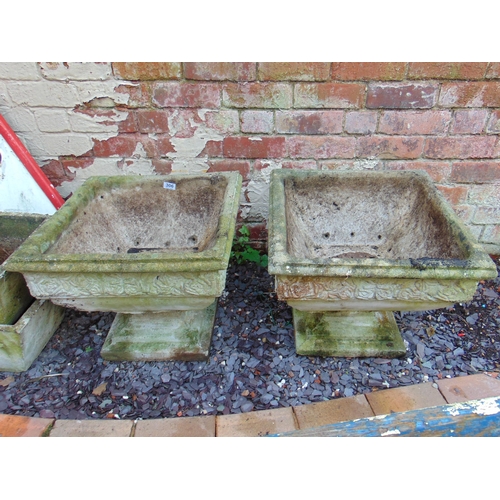 306 - Pair of square form stoneware garden planters on stands, each 17