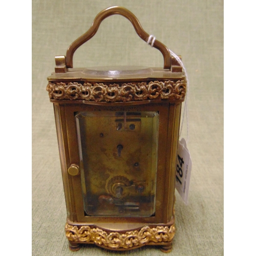 184 - Antique gilt metal mantle clock, having enamel face with Roman numerals.