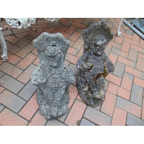 Two novelty garden ornaments, modelled as reclining gentlemen.