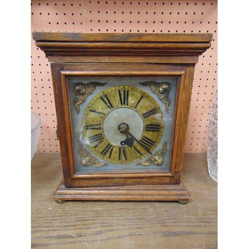 496 - Oak cased mantle clock, having brass dial and single fusee movement.