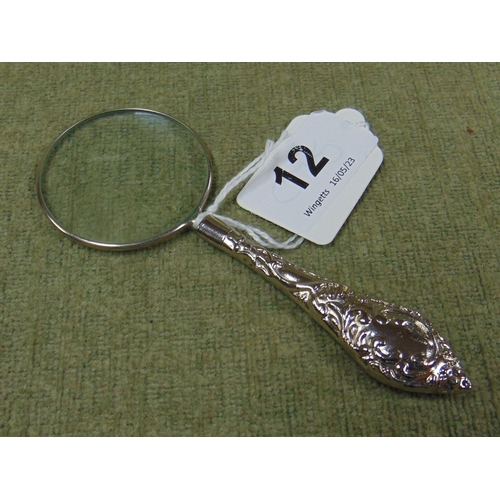 12 - Small magnifying glass, having embossed decoration. 5