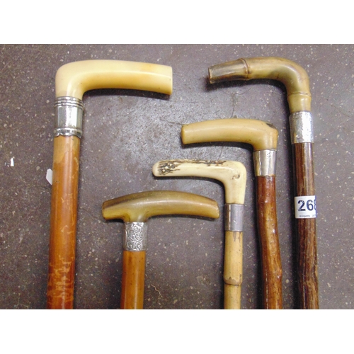 268 - Five silver mounted walking sticks.