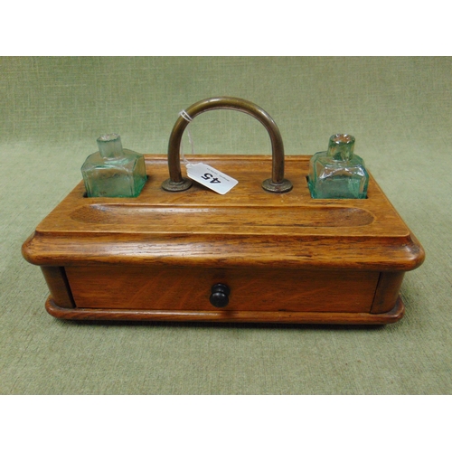 45 - Antique oak desk stand, having pair of glass ink wells and single drawer to base.