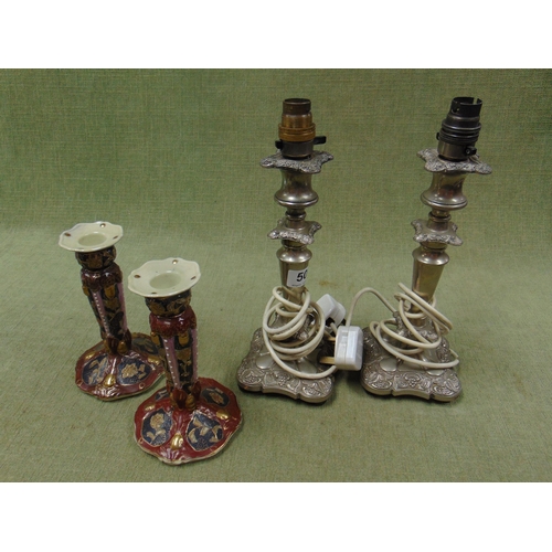 50 - Pair of silver plated table lamps and a pair of reproduction candlesticks.