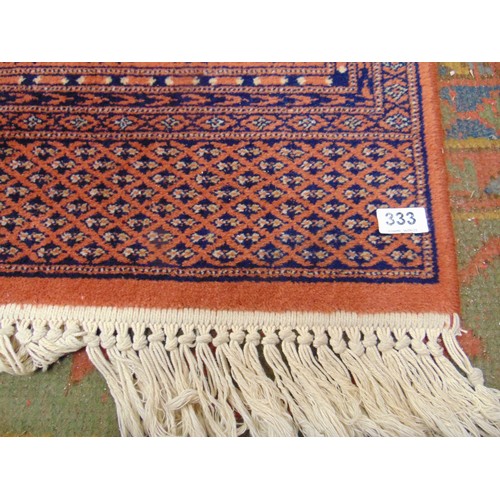 333 - Modern Bokhara salmon coloured rug. 118 x 77