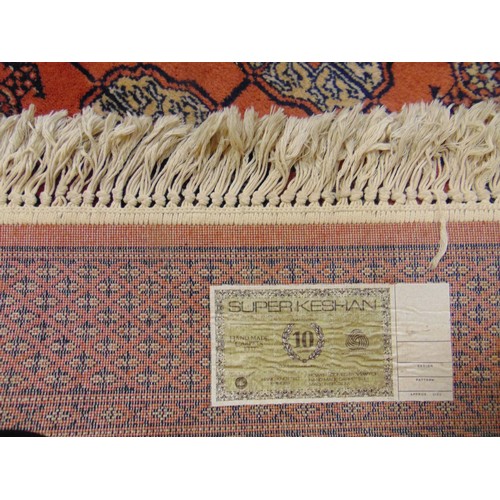 333 - Modern Bokhara salmon coloured rug. 118 x 77