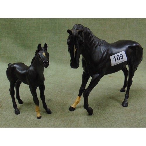 109 - Beswick matt black horse and a similar foal figure. (2).