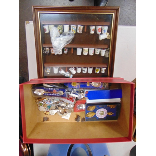 182 - Collection of thimbles in a glazed cabinet  and commemorative spoons.