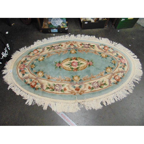 40 - Chinese oval floral pattern rug. 36.5 x 25.5