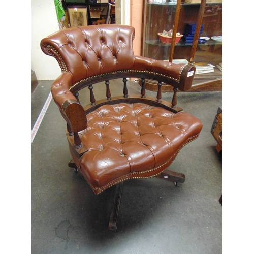 423 - Reproduction revolving office chair, having leather back, arms   and seat.