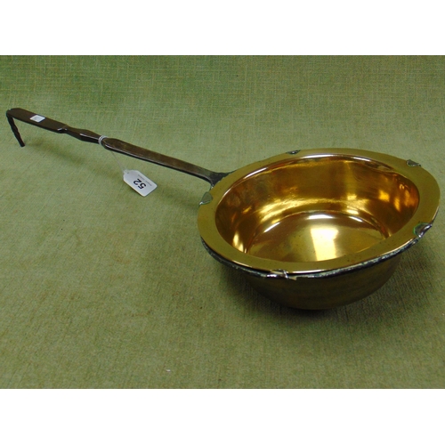 52 - Antique brass sauce pan, having steel handle.