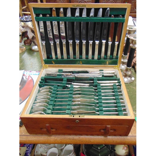 250 - An oak cased canteen of cutlery.