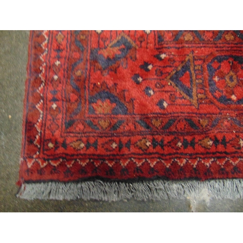 148 - Persian red ground rug, having geometric pattern. 91 x 61