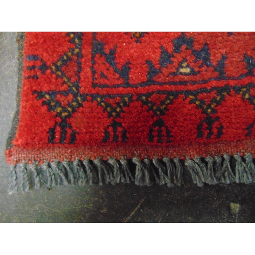 150 - Persian red ground rug, having geometric pattern. 49 x 30