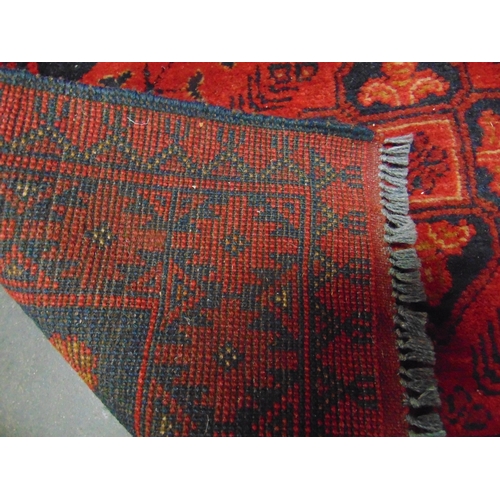 150 - Persian red ground rug, having geometric pattern. 49 x 30