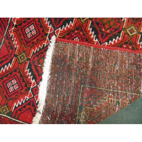 151 - Persian red and cream ground rug, having geometric pattern. 70 x 40