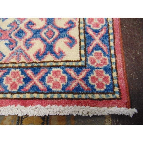 208 - Persian red, blue and yellow ground rug, having geometric pattern. 63 x 42.5