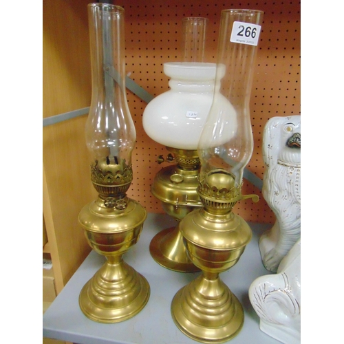 266 - Three brass paraffin lamps.