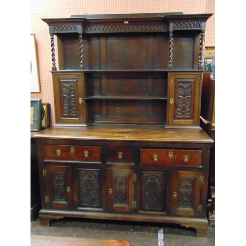 382 - An oak dresser, ogive cornice above barley twist columns, pair of cupboard doors, three short drawer... 