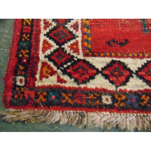 119 - Persian red ground rug, having geometric pattern, 95 x 64