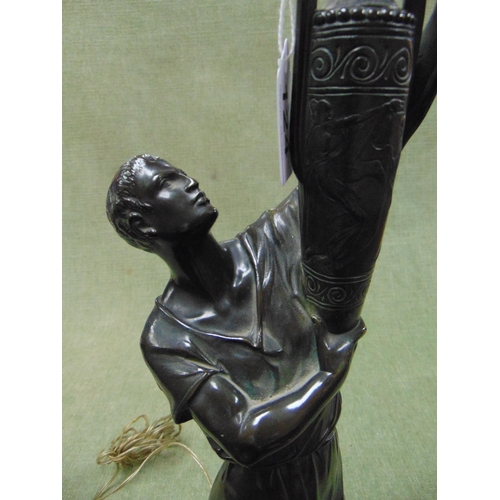 124 - Good bronze figural table lamp, modelled as a man holding an urn. 28