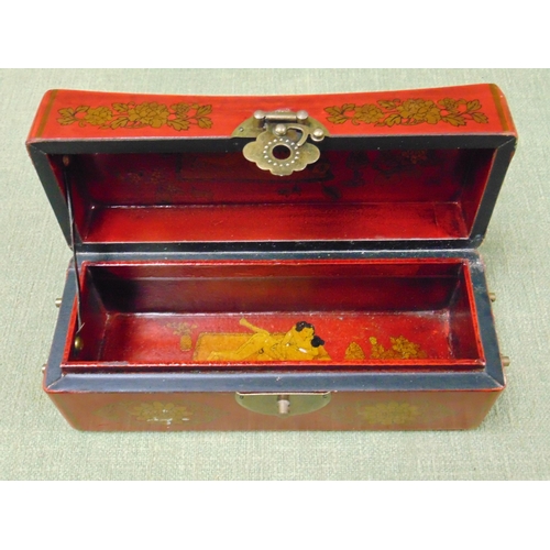 151 - Oriental red lacquered trinket box, having lift up lid revealing an erotic scene and side handles. 4... 