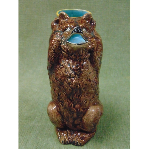 152 - Joseph Holdcroft English bear jug, modelled holding a drum aloft and forming the handle. 9.5