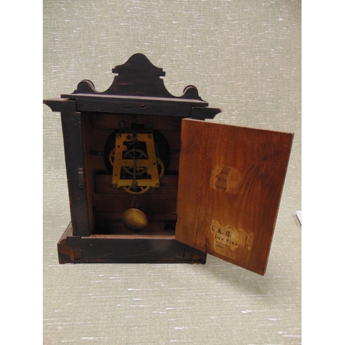 219 - Antique wooden mantle clock, having Arabic numerals.