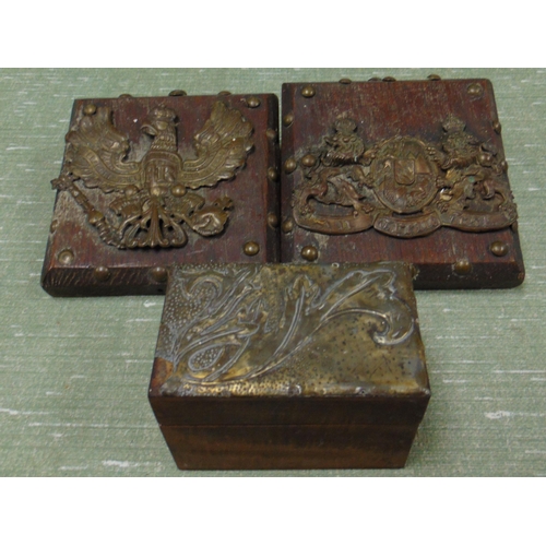 210 - Two brass armorial crests, and an Art Noveau trinket box.