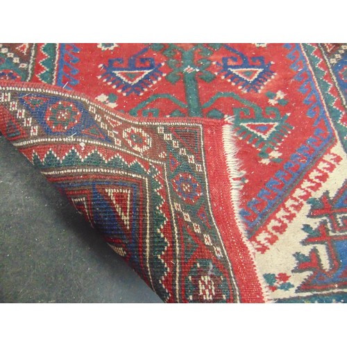 120 - Persian red and blue ground rug, 51 x 28