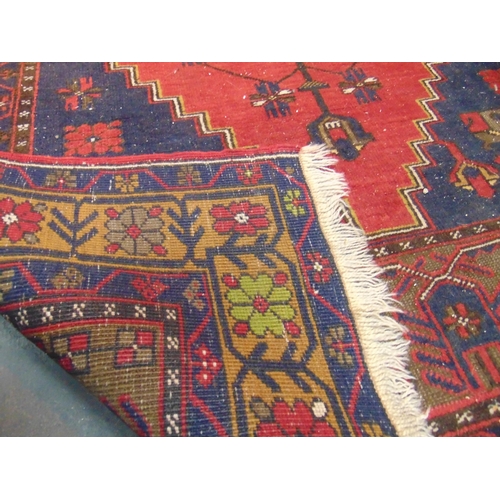 24 - Persian red and blue ground rug, having geometric pattern, 97 x 49