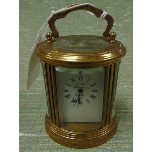 44 - Miniature French brass cased carriage clock, having enamel face and Roman numerals. 4