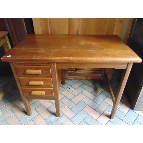 521 - An oak three drawer desk.